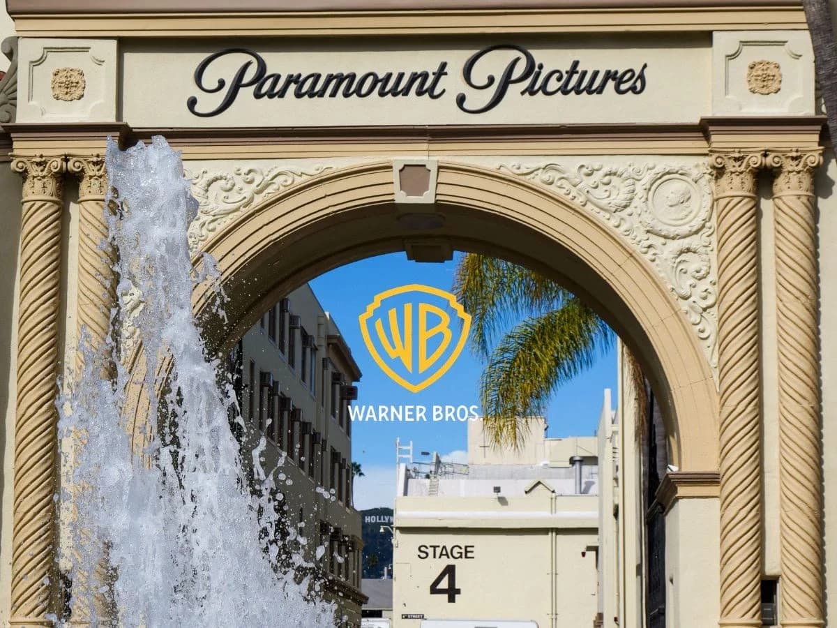 Skydance fusão Paramount e Warner Bros. Discovery: Portão do estúdio Paramount Pictures com fonte em primeiro plano e logotipo da Warner Bros. sobreposto ao céu