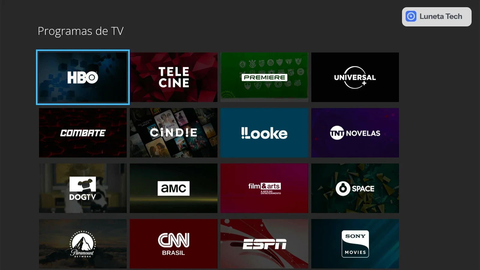 TV por assinatura e TV online: Captura de tela de menu "Programas de TV" com grade de canais em fundo escuro, com HBO, Telecine, Universal e outros.
